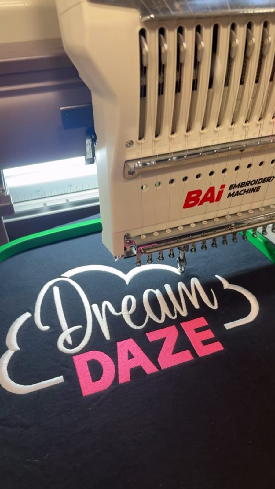 Dream Daze cloud logo being custom embroidered onto a navy hoodie in Depew, NY