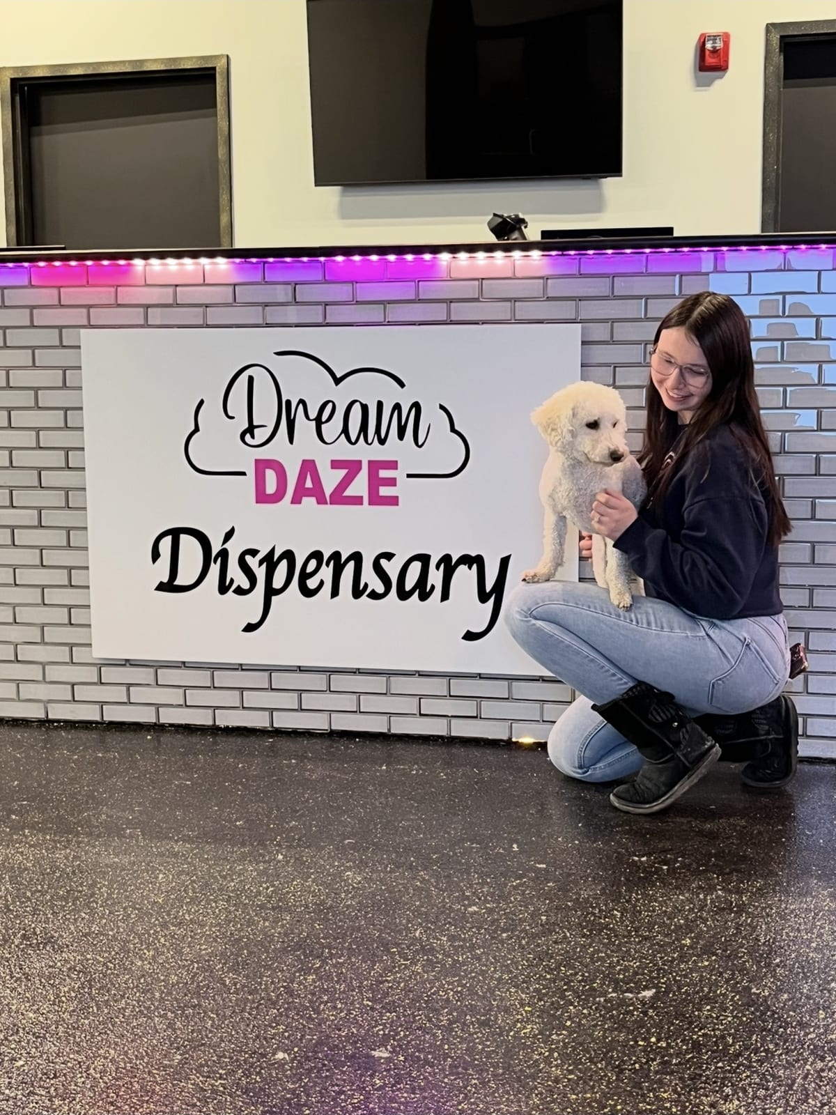Dream Daze shop dog by the dispensary sign